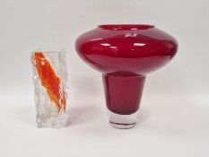 Brutalist style clear glass vase with raised geometric exterior pattern and orange and white