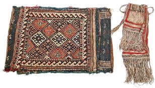 Woven wool saddle bag with two panels, each of hooked lozenge medallions with geometric running