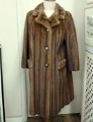 A full length mink coat, front pockets, horn button fastening