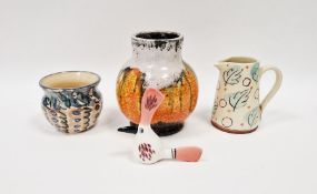 Annie Hewett terracotta jug with incised leaf decoration on blue brush marks over a cream ground,