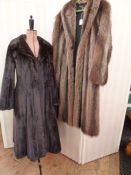 A full-length ranch mink coat labelled Maxwell Croft of London, and a full-length raccoon coat