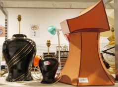 Large table lamp of baluster form with black glaze and gilt decoration and another smaller similar