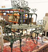 Painted metal Coalbrookdale-style garden table, oval with under-shelf, four chairs and a smaller