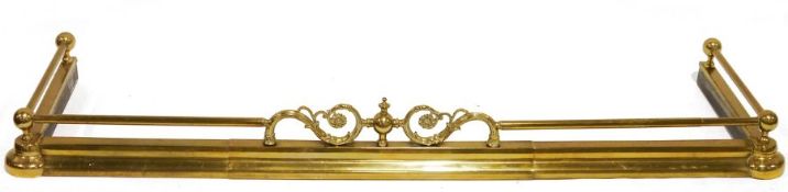 Adjustable brass fire curb with decorative scroll decoration to the centre