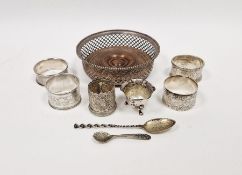 Four assorted engraved napkin rings, a silver salt and a silver-mounted wine coaster marked '