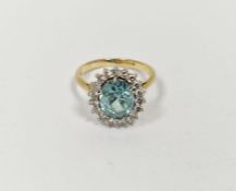 18ct gold yellow gold, diamond and blue stone ring, the oval central stone aquamarine in colour