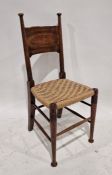 Arts & Crafts-style hardwood dining chair with curved panel back, turned uprights, woven string