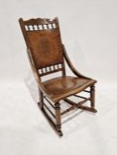 Oak rocking chair with wooden panelled back and seat
