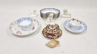 Three 19th century Staffordshire pottery and porcelain models of poodles on cushions, tallest 9cm