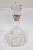 Cut glass ship's decanter of traditional form with silver collar and facet cut ball stopper, 27cm