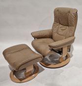 Ekornes Stressless reclining and revolving armchair with footstool, upholstered and covered in beige