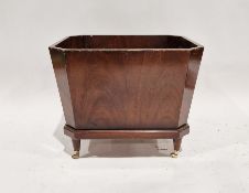 19th century mahogany cellarette, sarcophagus form, on tapering supports with brass castors (lacking