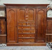 19th century mahogany compactum with stepped ogee and cavetto cornice, central linen cupboard, an