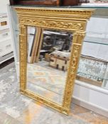 Giltwood wall mirror of revived classical style, rectangular with stiffleaf moulded cornice and