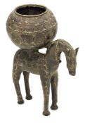 Possibly North African cast metal model of a horse bearing a spherical pot, allover whorl