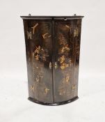 Edwardian chinoiserie lacquered bowfronted corner cupboard with three shelves and decorated with