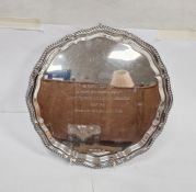 LOT WITHDRAWN Silver salver with gadrooned serpentine border, inscription to top, on three scroll