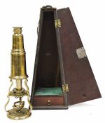 Early 20th century brass microscope housed in original fitted wooden box, 26cm high fitted four