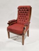 Victorian mahogany button back arm chair, with red and gold upholstery and scrolling arms, front