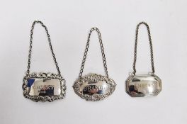 Two hallmarked silver decanter labels and a silver plated example, for whisky, sherry and brandy,