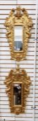Pair of ornate gilt wall mirrors, each with stylised putti motifs amongst scrolling foliage,