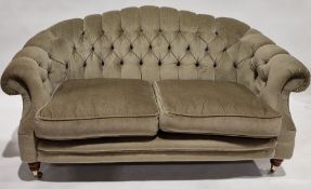 Green dralon button upholstered two-seater settee with loose cushions and on turned stump supports
