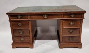 20th century oak pedestal desk with green leather top, an arrangement of nine drawers around the