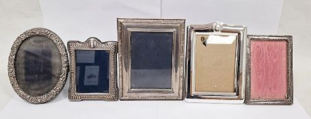 Collection of four silver mounted photograph frames and another, four of rectangular form, the other