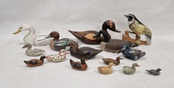 Assortment of carved wooden ducks and other birds, including decoys, some having painted decoration,