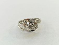 14ct white gold and diamond dress ring set three central claw set stones, the centre stone 0.35ct