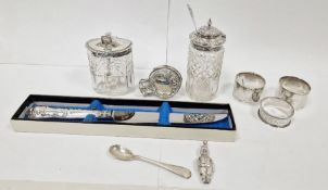 One silver-topped and one white metal cut glass condiments, a silver part rattle of Mr Punch and a