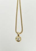 18ct gold and diamond pendant on chain necklace, the diamond in circular mount, 5mm diameter