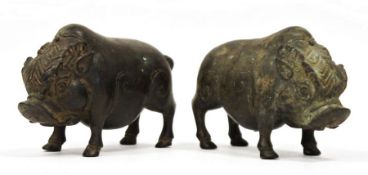 Pair of chinese, or possibly Indonesian, bronze standing boars, each with patterned headdress,
