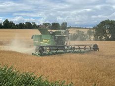 The following lot is being sold for the National Autistic Society Charity. Combine harvester driving