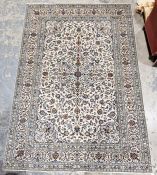 Central Persian cream ground Kashan carpet with central floral medallion on floral field, floral
