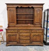 Georgian-style reproduction oak dresser with mahogany cross banding, having shaped frieze, two