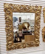 Reproduction ornate gilt wall mirror, rectangular with deep foliate scroll frame, 125cm x 105cm
