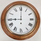 Oak cased circular wall clock with white painted face and roman numerals, Maltese cross design