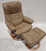 Ekornes Stressless reclining and revolving armchair with footstool, upholstered and covered in beige