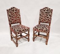 Set of four reproduction oak dining chairs, each with broken arched padded back and seat, in