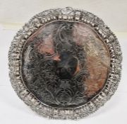 Continental silver-coloured metal salver, floral engraved initial 'A', unmarked, on scroll feet,