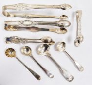 Four silver sugar tongs and four silver spoons, various dates and makers, 128.5g, 4ozt approx. in