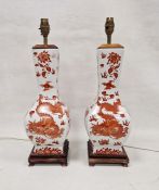 Two modern Chinese-style lamp bases, printed in iron red with scrolling dragons chasing flaming