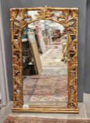 Reproduction gilt wall mirror with ornate pierced foliate border, 121cm x 73cm