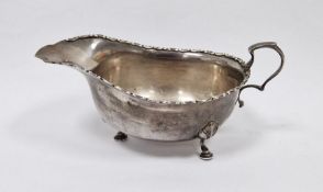 LOT WITHDRAWN Early 20th century silver sauceboat with scroll-shaped handle, on three spade feet,