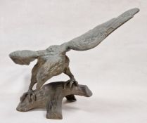 Large metal model depicting eagle perched upon a branch, with wings spread, 32cm high approx.
