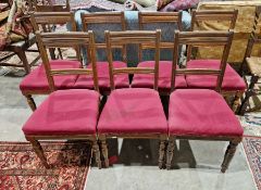 Set of seven oak railback dining chairs, each with two channelled cross rails and stuffover seats,