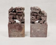 Pair of Chinese carved soapstone figures of dogs of fo, 20th century, on rectangular bases,