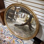 Giltwood oval wall mirror with embossed frame and bevelled plate, 70cm x 85cm