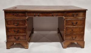 Modern walnut pedestal desk with red leather inset top, an arrangement of nine drawers around the